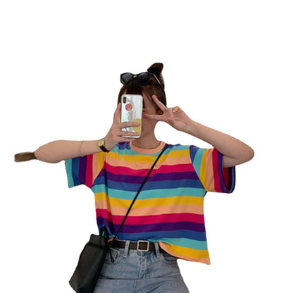Woman wearing Rainbow Stripe Loose T Shirt in a sunny outdoor setting