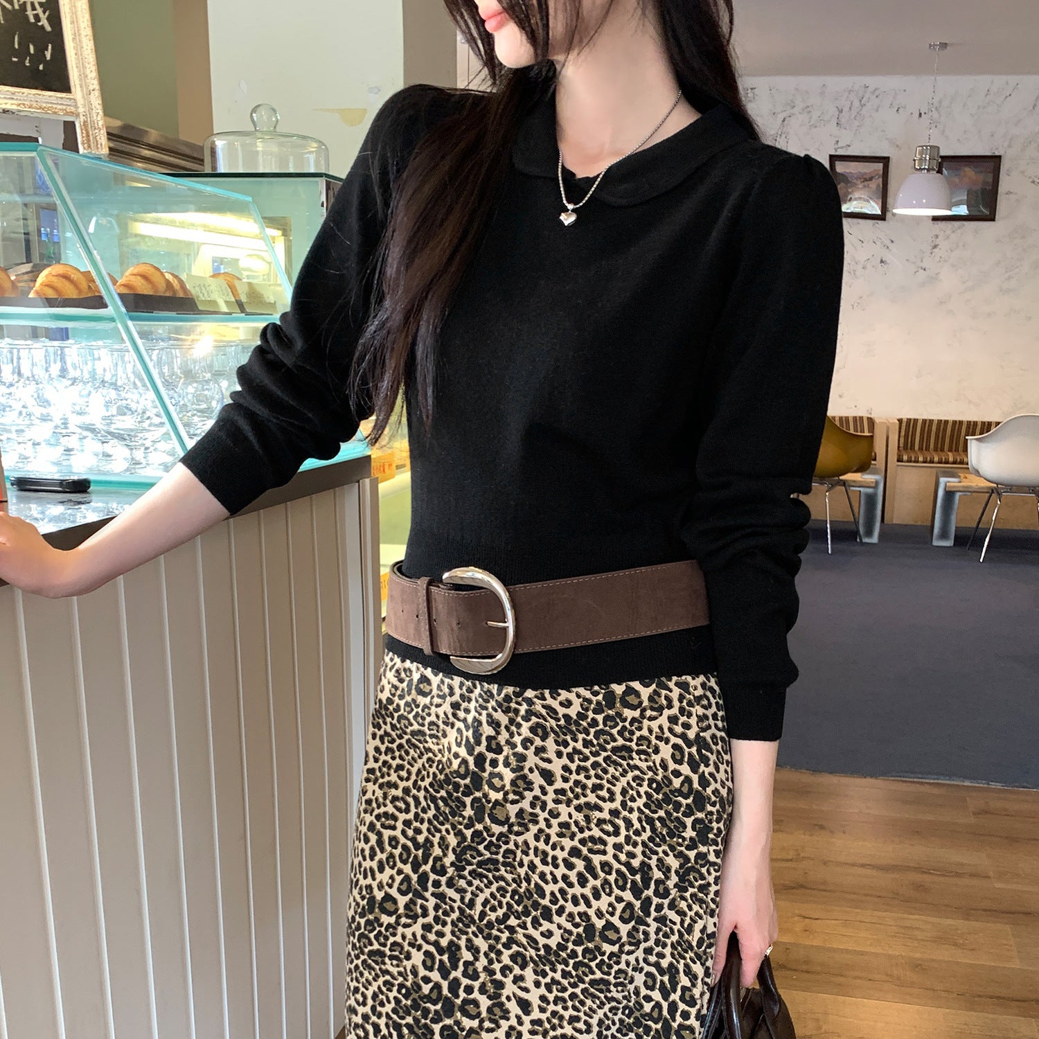 Woman wearing Peter Pan Collar Waist-Cinching Bodysuit in a stylish setting