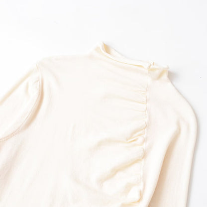 Woman wearing Irregular Pleated Long Sleeve Top in a casual setting