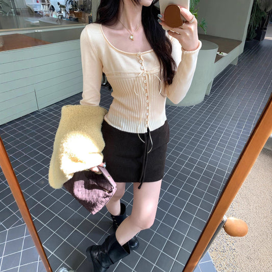 Woman wearing Solid Colour Slim Fit Long Sleeve Knit Top in a stylish setting