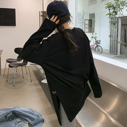 Woman wearing Solid Color Side Slit Long Sleeve T-Shirt in a casual setting