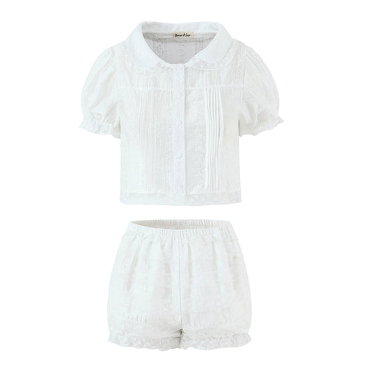 Woman wearing Baby Collar Pleated Top and Cake Layer Shorts Set in a sunny outdoor setting