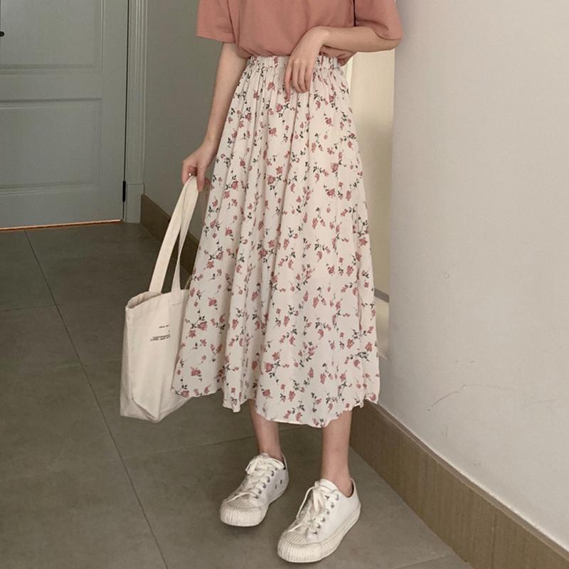 Woman wearing Floral Bohemian A-Line Midi Skirt in a sunny park