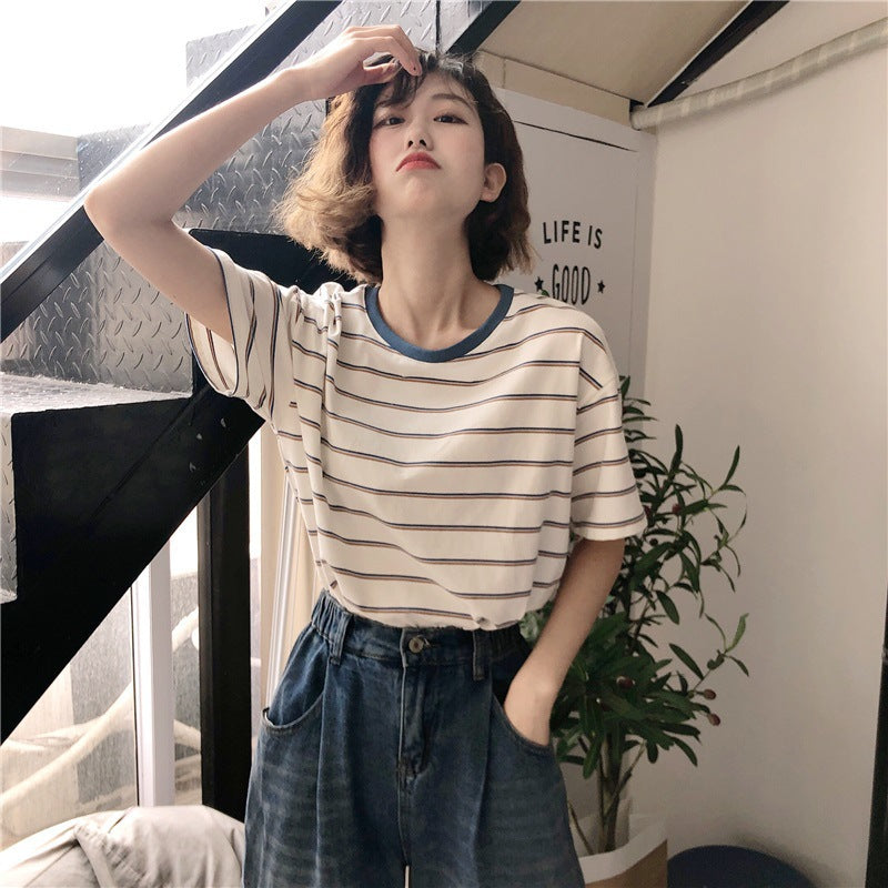 Woman wearing Academy Style Loose Fit Striped T-Shirt in a casual setting
