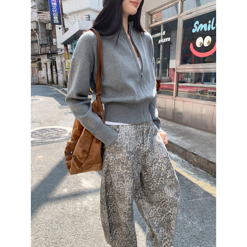 Woman wearing zippered long sleeve knit cardigan coat in urban setting