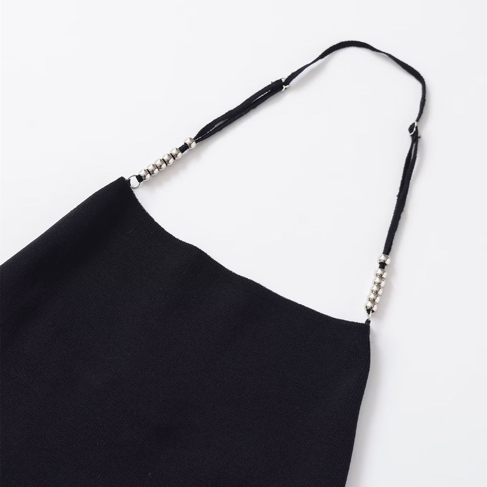 Woman wearing Backless Adjustable Metal Ball Slim Shoulder Top in a chic urban setting