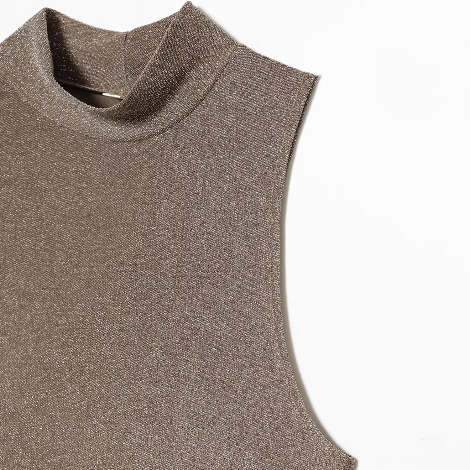 Woman wearing metallic sleeveless dress in a casual setting