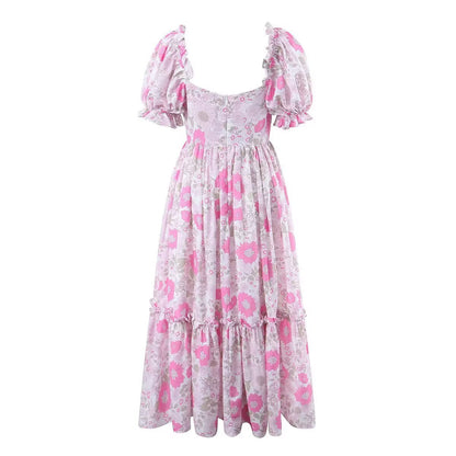 Woman wearing Floral A-Line Long Dress with Puff Sleeves in a sunny garden