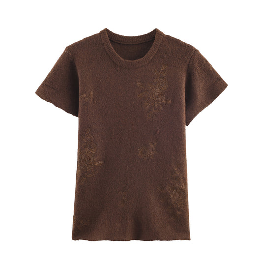 Woman wearing Embroidered Short Sleeve Knitted Top in a casual setting