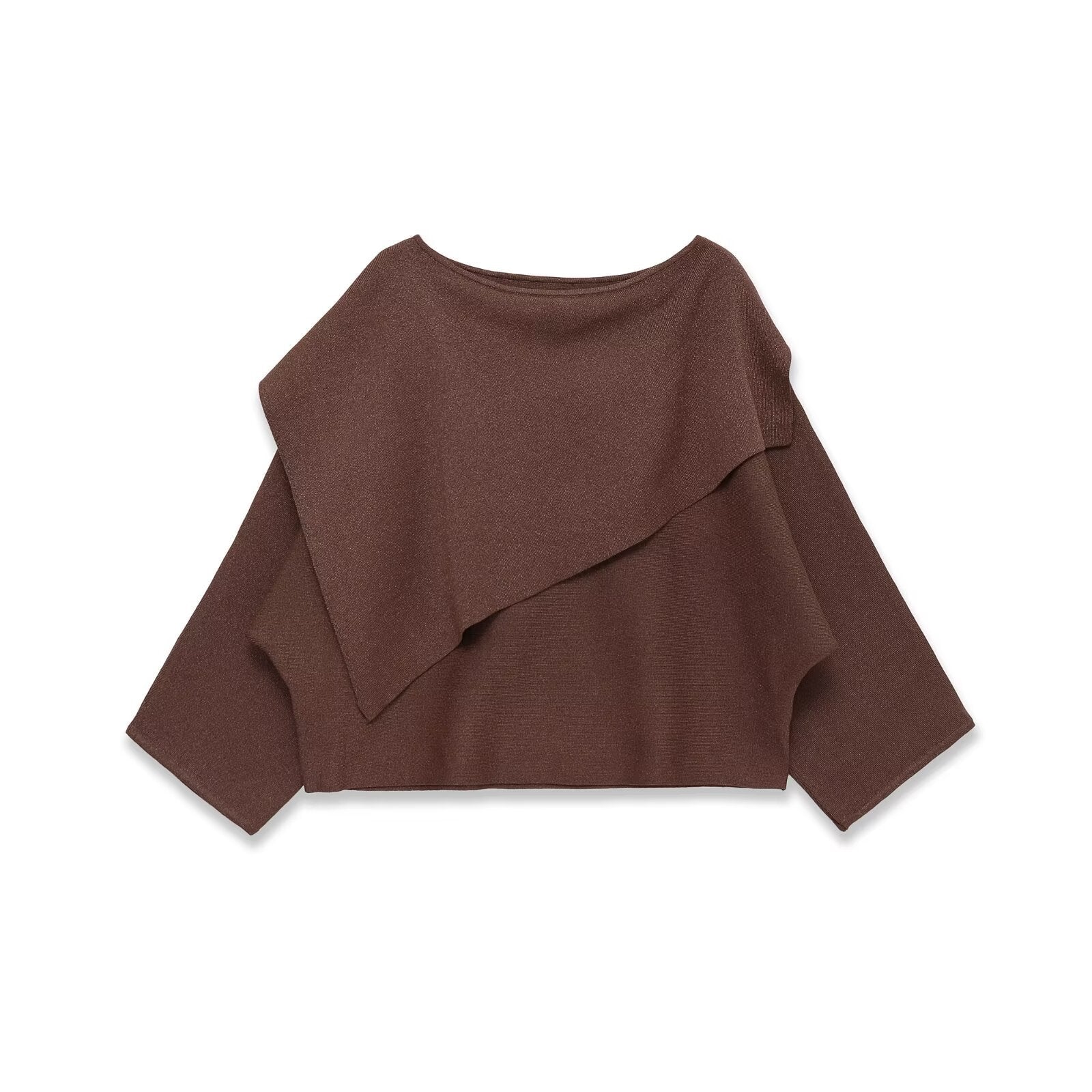 Woman wearing Loose Metallic Thread Knitted Cape Pullover in a cozy setting