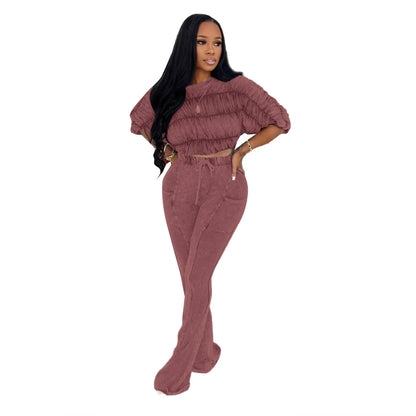 Woman wearing Flattering Two Piece Set with Crop Top and Flared Pants in a stylish urban setting