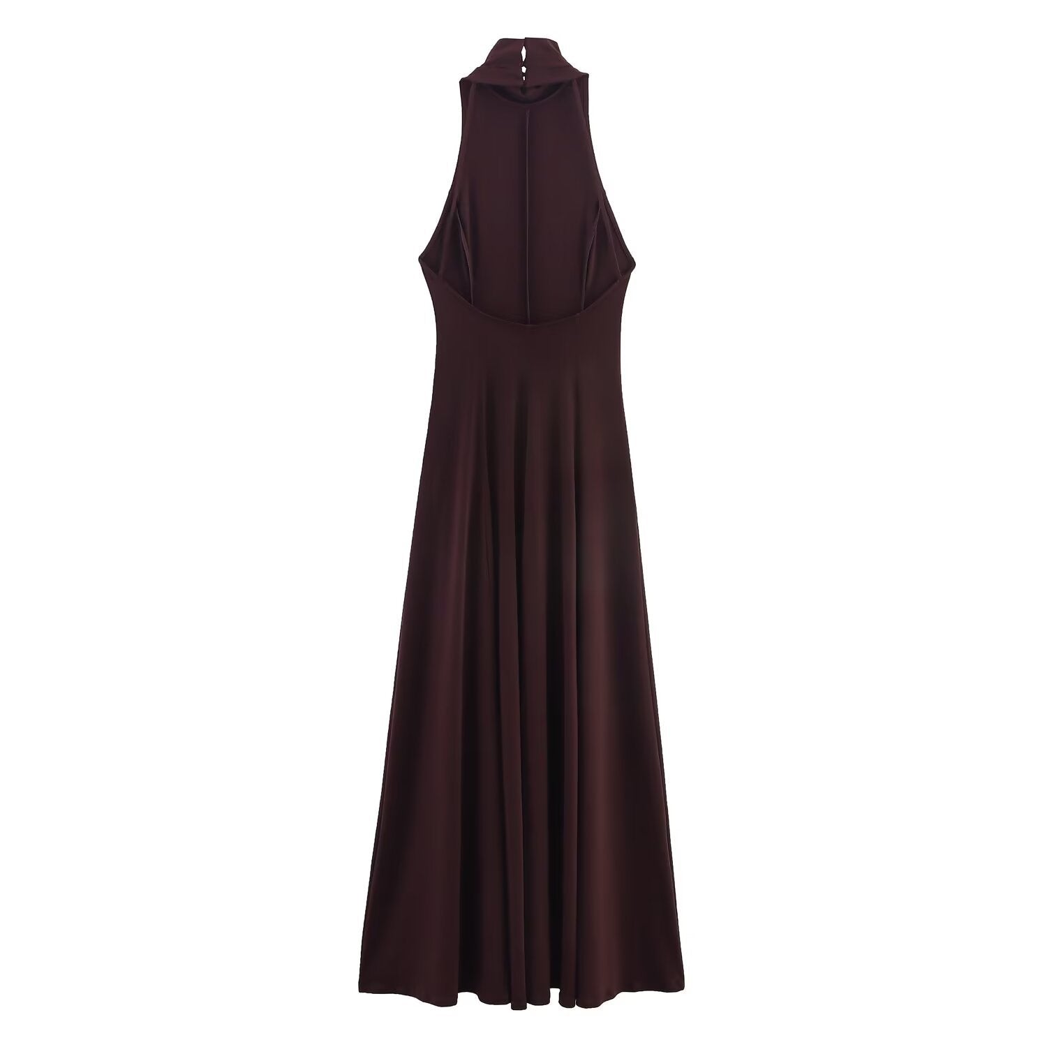 Woman wearing backless long dress in a sunny outdoor setting