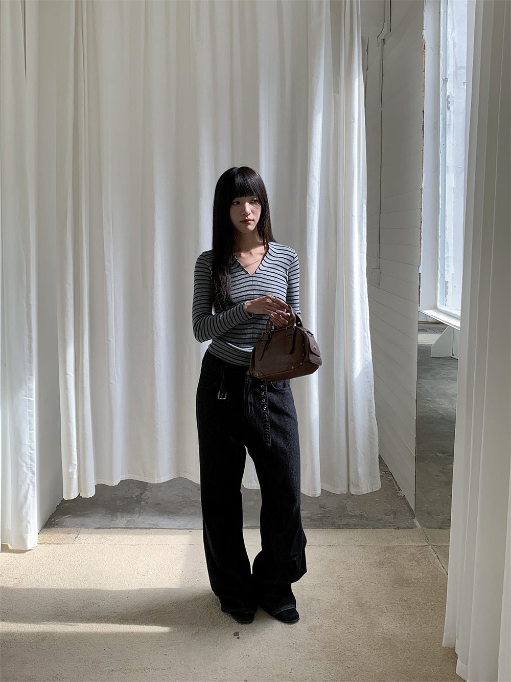 Woman wearing Raw Denim Faux Belted Straight Leg Jeans in a casual setting