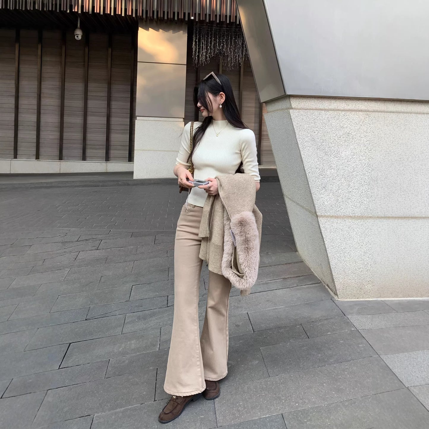 Woman wearing Half-High Neck Slim Fit Knit Top in a stylish setting
