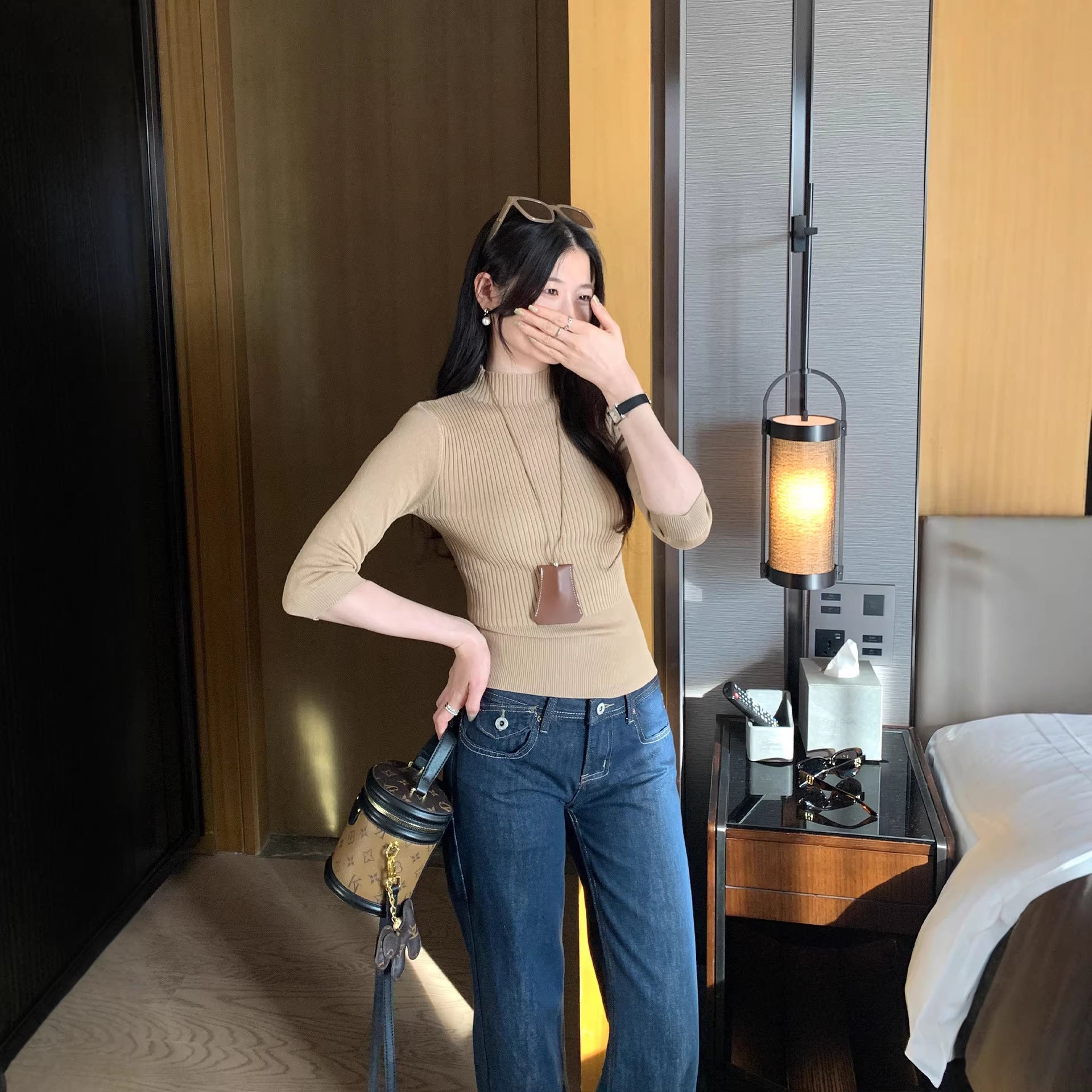 Woman wearing Half-High Neck Slim Fit Knit Top in a stylish setting