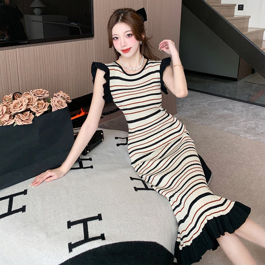 Woman wearing Women’s Striped Knitwear Dress in a sunny outdoor setting