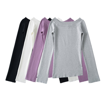 Woman wearing One Shoulder Slit Slanted Hem Top in a stylish setting