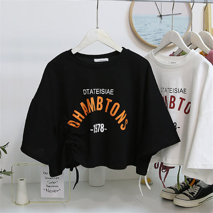 Woman wearing Chic Drawstring Cropped Top in a casual setting