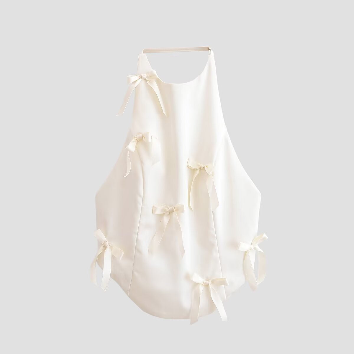 Woman wearing Spicy Girl Bow Decoration Halter Neck Top in a sunny outdoor setting