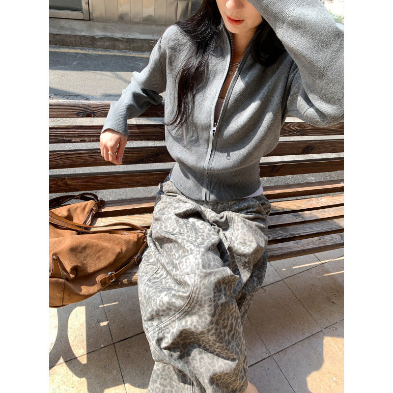 Woman wearing zippered long sleeve knit cardigan coat in urban setting