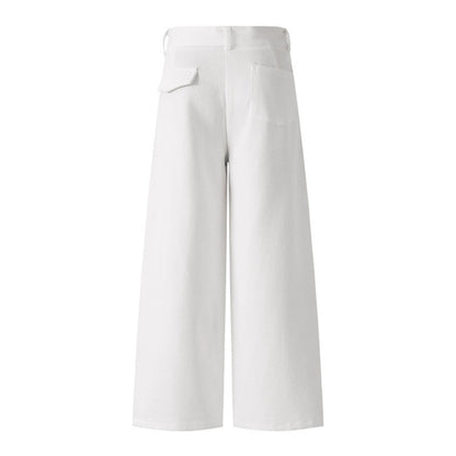 Woman wearing casual white denim pants in a trendy urban setting