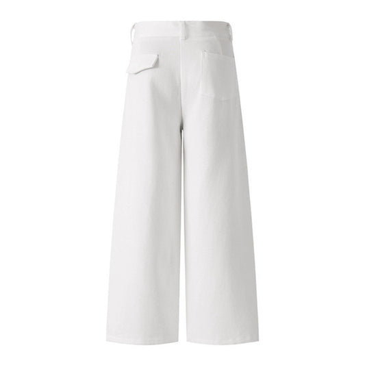 Woman wearing casual white denim pants in a trendy urban setting