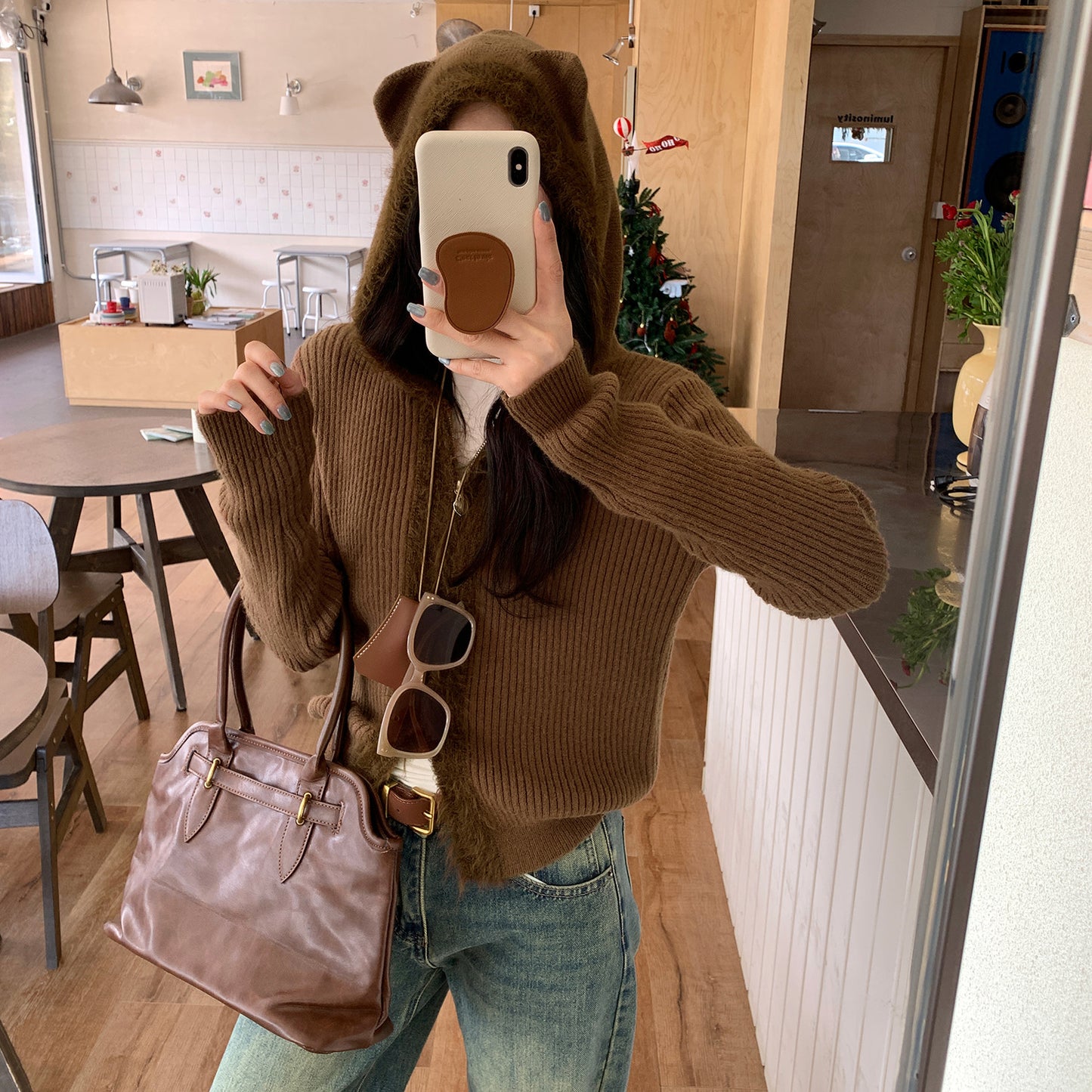 Woman wearing Hooded Knit Cardigan with Fur Collar in a cozy setting