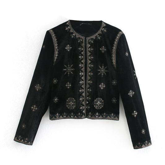 Woman wearing Royal Embroidered Velvet Coat in an elegant setting
