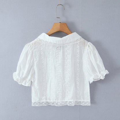 Woman wearing Baby Collar Pleated Top and Cake Layer Shorts Set in a sunny outdoor setting