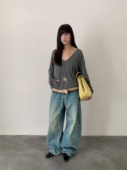 Woman wearing Deconstructed Wide Leg Denim Pants in a city setting