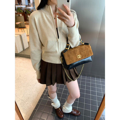 Woman wearing zippered long sleeve knit cardigan coat in urban setting