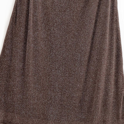 Woman wearing French Backless Metallic Dress in an elegant setting