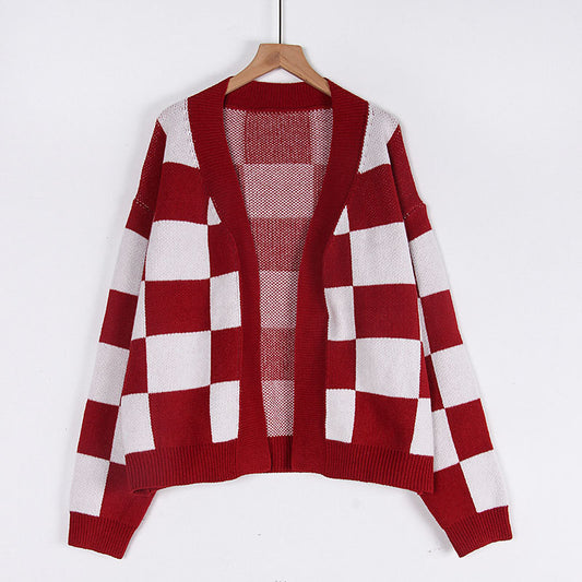 Woman wearing plaid cardigan sweater in a cozy setting