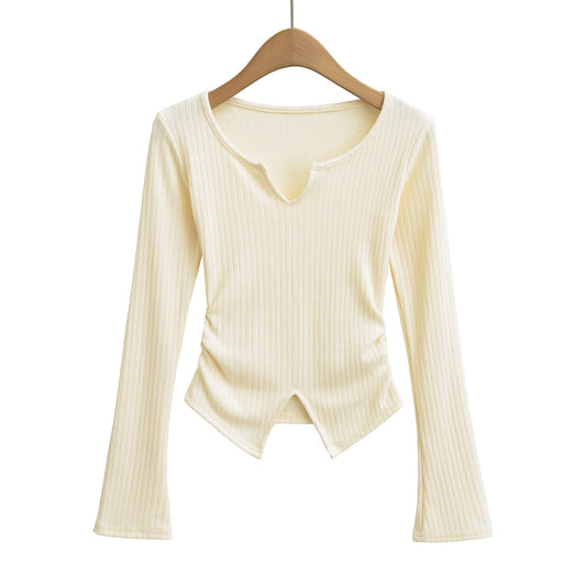 Woman wearing V-Neck Slit Pleated Long Sleeve Pullover in a stylish urban setting
