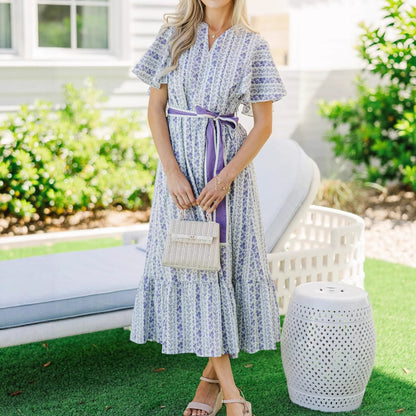 Woman wearing Bohemian Floral Ruffle Maxi Dress in a garden