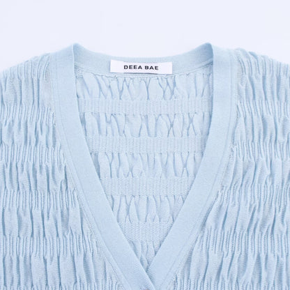 Woman wearing Light Blue Pleated Knitted Jacket in a casual setting
