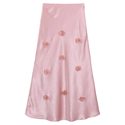 Woman wearing 3D floral skirt in a garden setting
