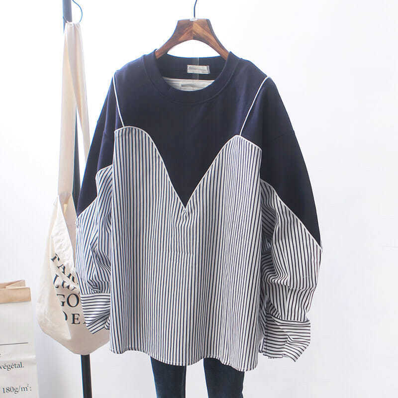 Woman wearing Patchwork Striped Oversized Hoodie in a casual street setting
