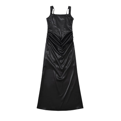 Woman wearing backless camisole dress in a summer setting