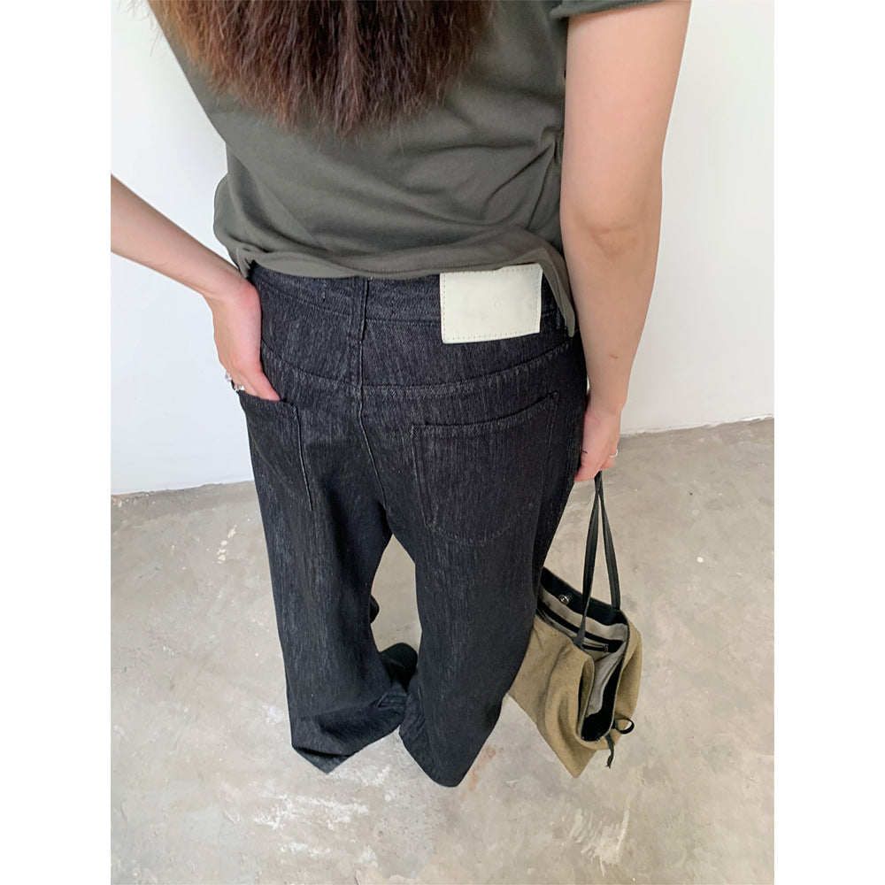 Woman wearing Raw Denim Faux Belted Straight Leg Jeans in a casual setting