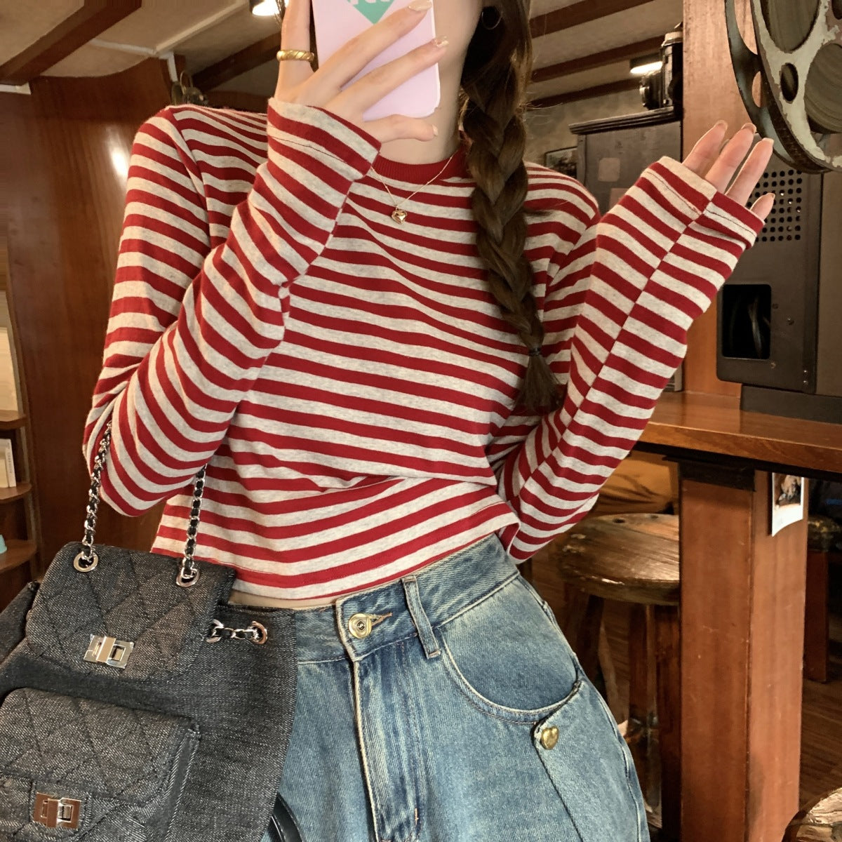Woman wearing Stripe Long Sleeve Crop Top in a casual setting