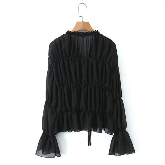 Woman wearing V-Neck Pleated Strap Long Sleeve Top in a stylish setting