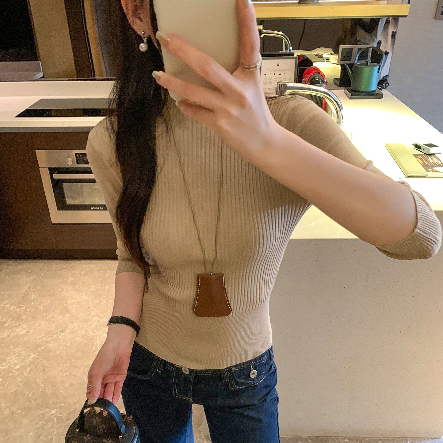 Woman wearing Half-High Neck Slim Fit Knit Top in a stylish setting