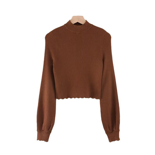 Woman wearing Half High Neck Lotus Leaf Hem Knit Top in a chic setting