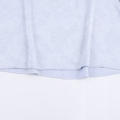 Woman wearing Embroidered Satin Bow Detail Blouse in a chic setting