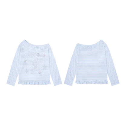 Woman wearing Anime Print Asymmetric Neck Long Sleeve Top in a casual outdoor setting