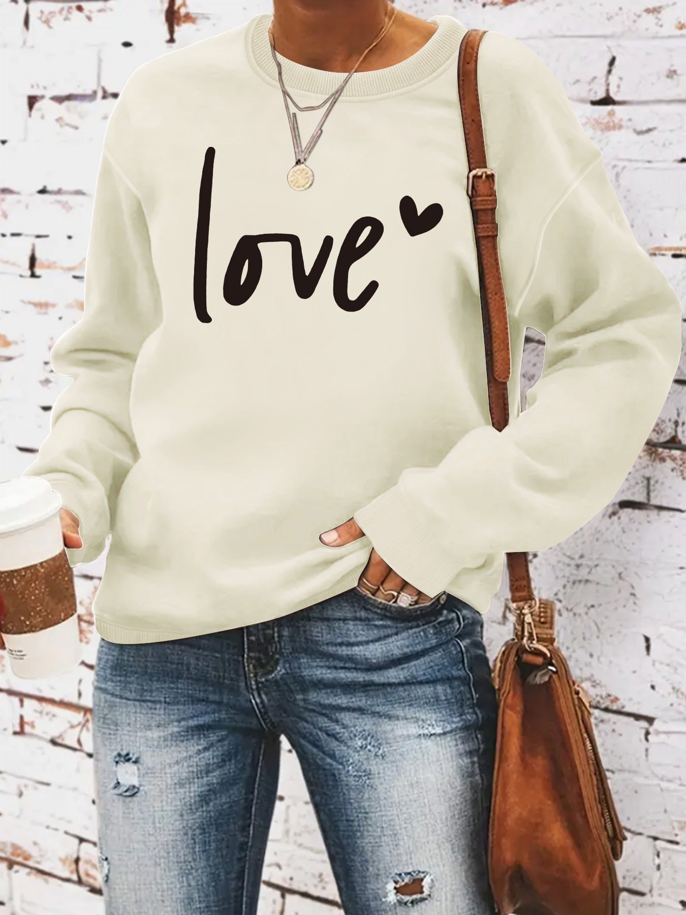 Woman wearing Love Printed Hoodie in a casual setting