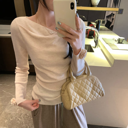 Woman wearing Boat Neck Long Sleeve Slim Fit Knit Top in a stylish setting