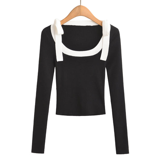 Woman wearing Square Neck Bow Ribbon Slim Fit Long Sleeve Sweater in a chic urban setting