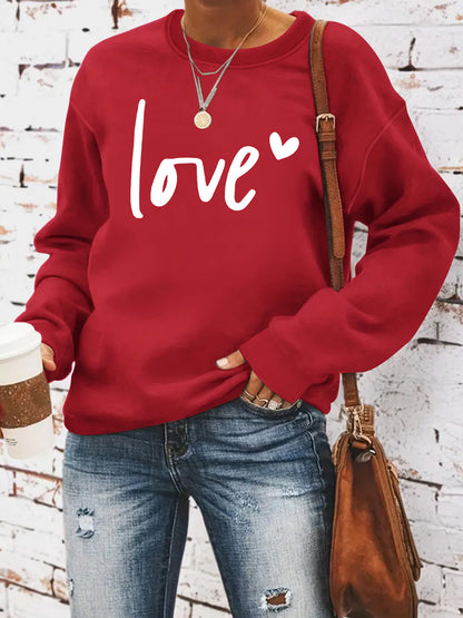Woman wearing Love Printed Hoodie in a casual setting